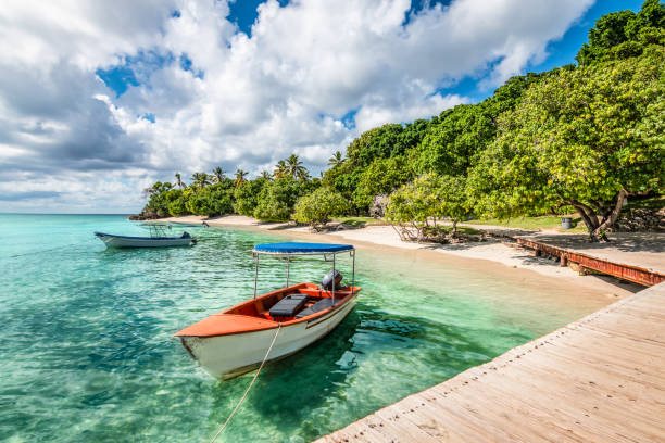 A traditional wooden boat moored at a jetty in Samaná Bay