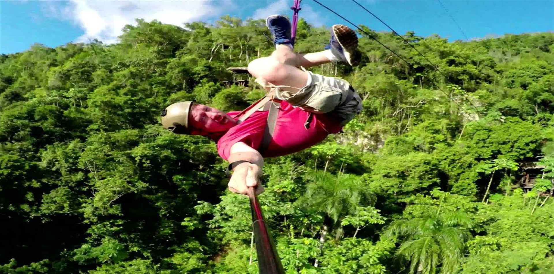 Rider crossing the jungle canopy on a zipline in El Valle